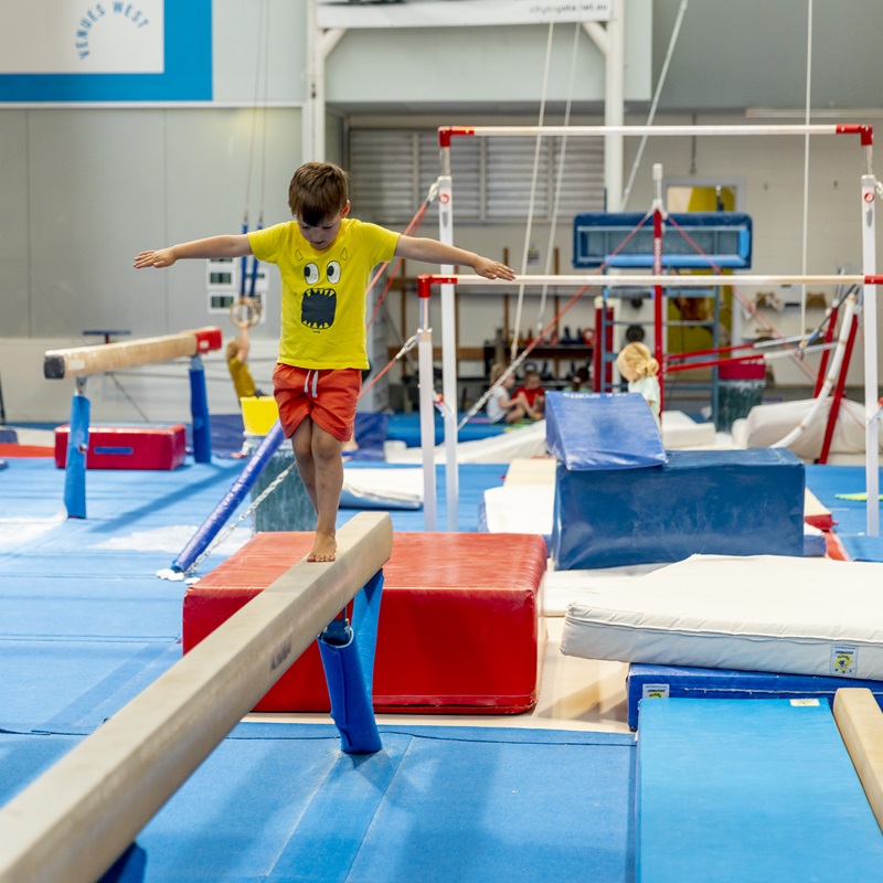 Young boy walking on balance beam