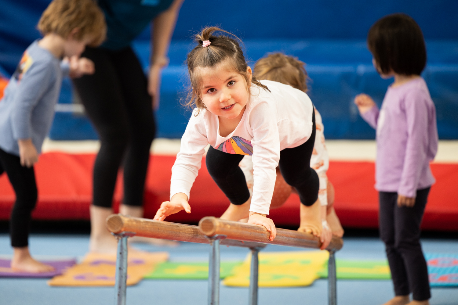 A child standing a ser of horizontal bars at the HBF Stadium Kids Gymnastics in Mount Claremont, Perth